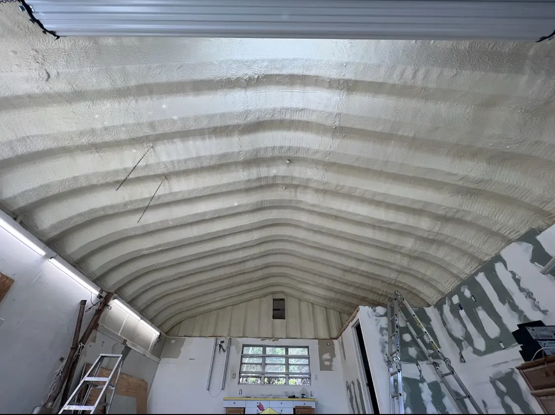 Spray polyurethane foam applied to the underside of a metal roof deck in Belding